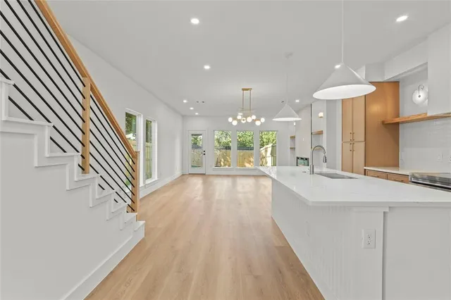 wooden floor with a chandelier