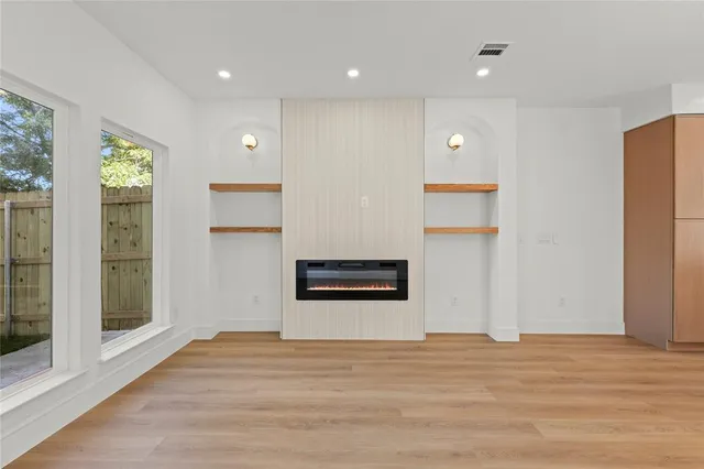 a view of a kitchen with a refrigerator and a window