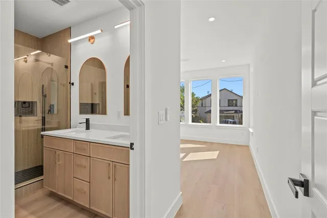 a en suite bathroom with a granite countertop sink and a mirror