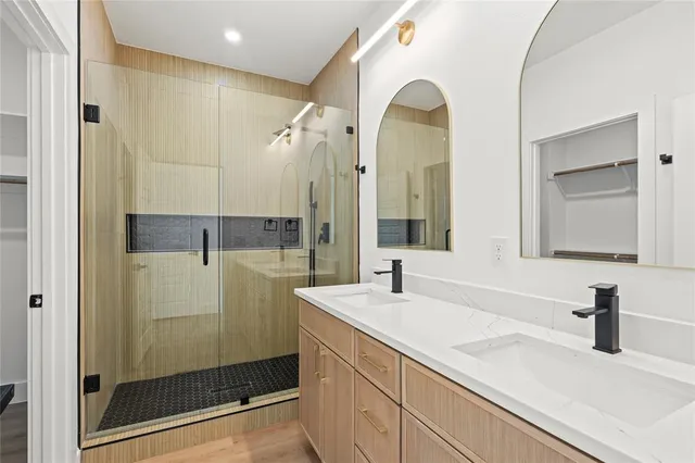 a bathroom with a shower sink and mirror