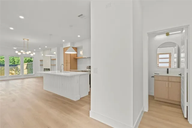 a view of a kitchen with a sink and a large window