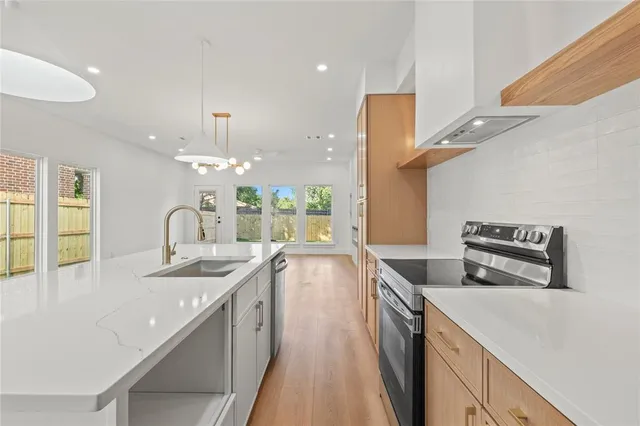 a kitchen with granite countertop a stove and a sink