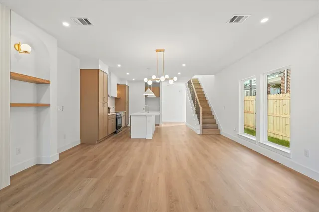 a view of a room with wooden floor and a ceiling fan