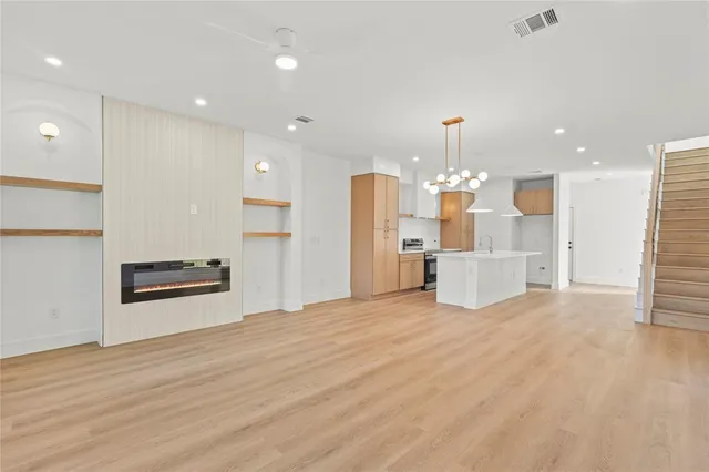 a large kitchen with kitchen island a stove a refrigerator and a sink