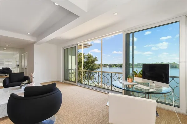 a hallway with a large window and couch