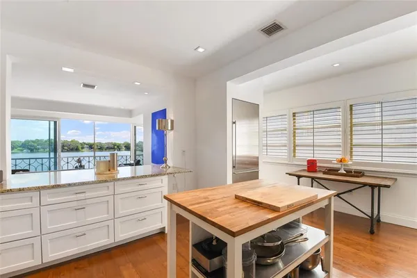 a view of a living room hardwood floor and a floor to ceiling window
