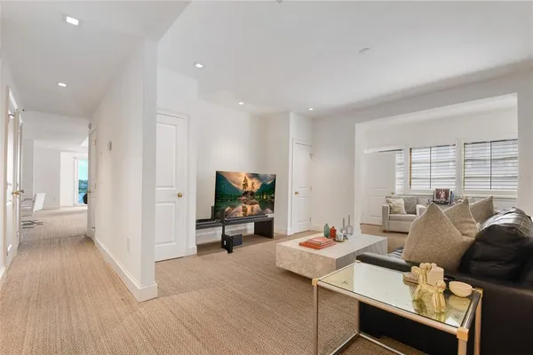 a living room with a couch and a book shelf