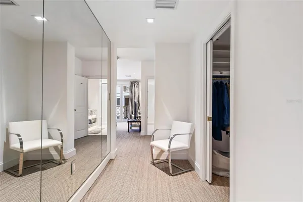 a bedroom with a bed and large flat screen tv