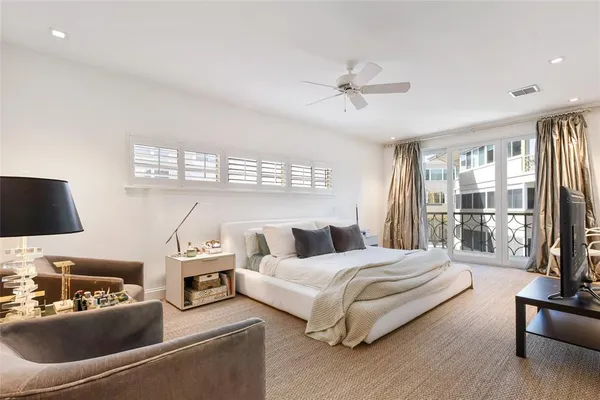 a bedroom with a large bed and a window