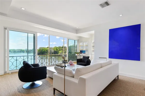 a living room with couch and a large window