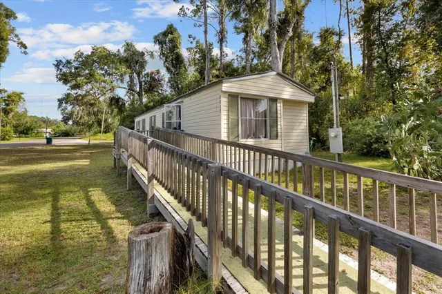 a balcony with wooden floor and trees