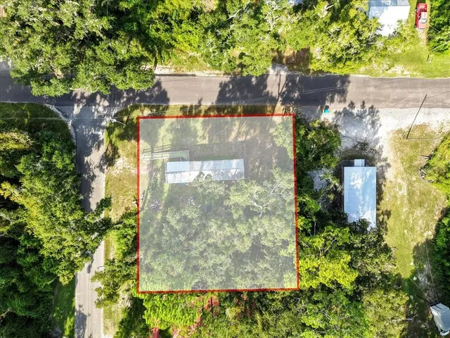 an aerial view of a residential houses with trees