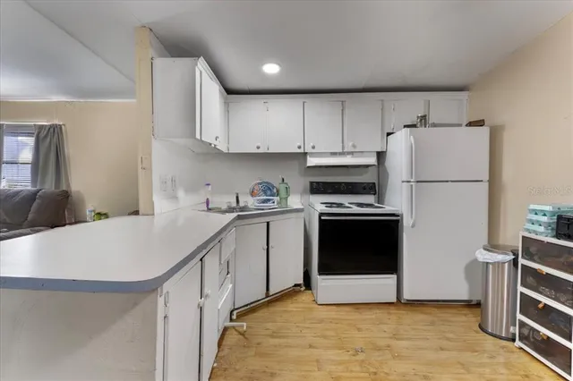 a kitchen with cabinets and white appliances