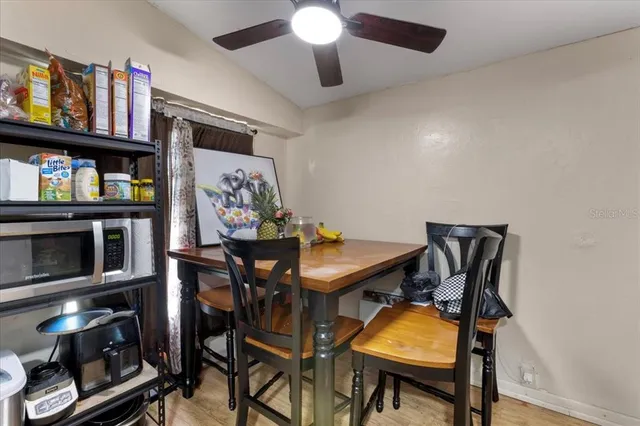 a view of a dining room with furniture and a kitchen