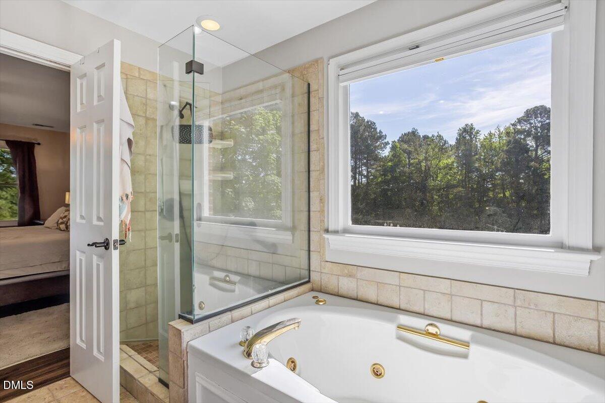 1468 Frazier Road Spring Hope, NC 27882 - Photo 22 of 71 a bathroom with a tub and a shower