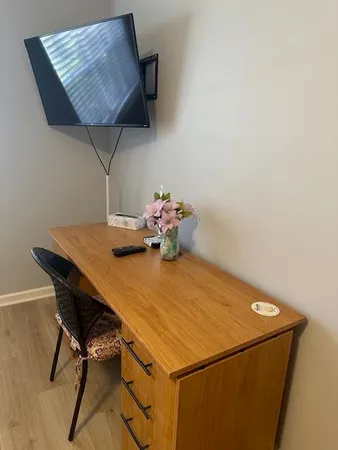 a room with a table chairs and a chandelier