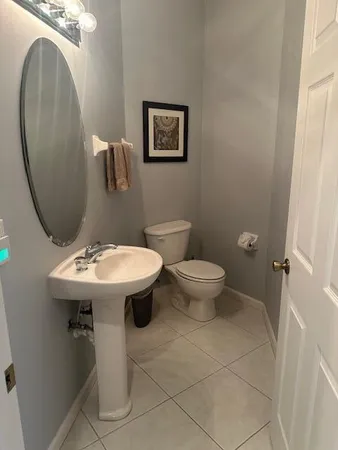 a bathroom with a sink toilet and a mirror