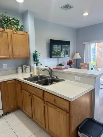 a kitchen with a sink cabinets and a window
