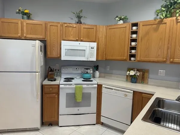 a kitchen with a refrigerator sink and stove