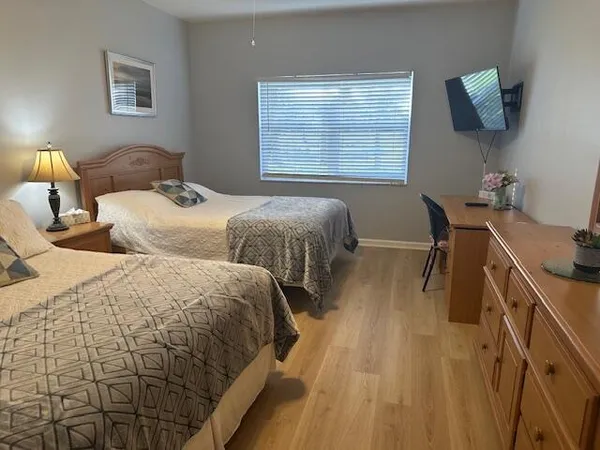 a bedroom with two beds and a window