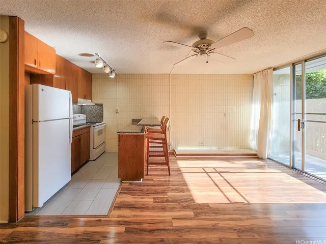 a kitchen with stainless steel appliances a refrigerator and a stove top oven