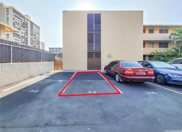 a view of a backyard with table and chairs potted plants and tree