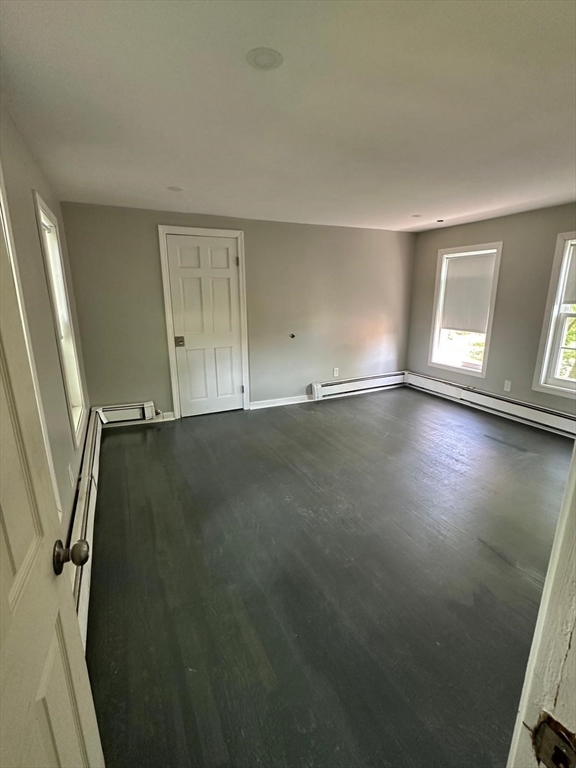 465 North Main Street, Unit 2 Randolph, MA 02368 - Photo 4 of 4 an empty room with wooden floor and windows