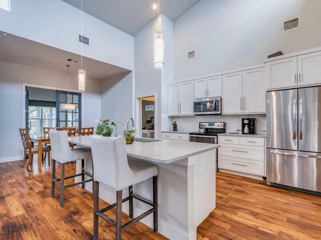 a kitchen with stainless steel appliances a refrigerator stove microwave and cabinets