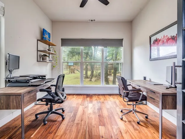 a workspace with wooden floor and a window