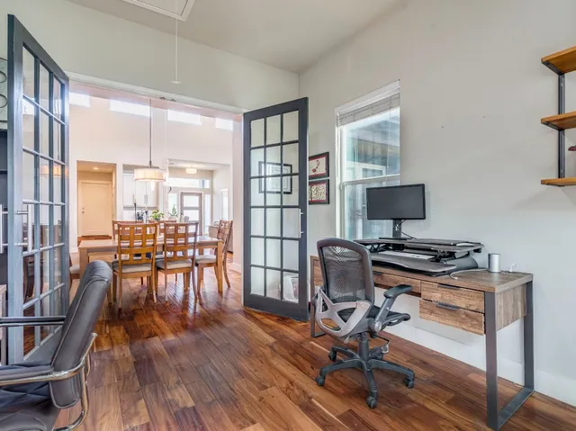 a view of a workspace with furniture and a living room