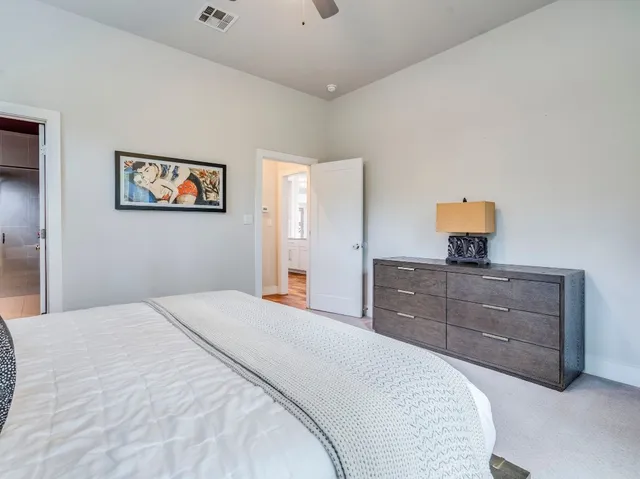 a bedroom with a bed and a dresser