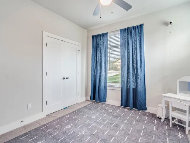 a view of a bedroom with a furniture and a window