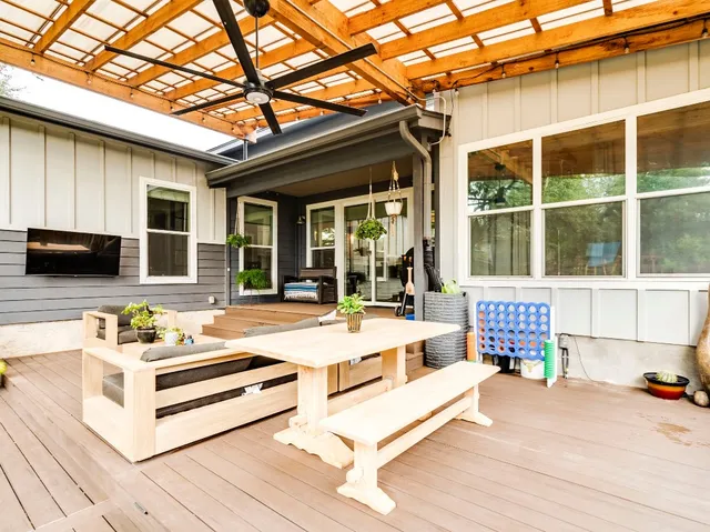 a view of a white house with a large windows and wooden roof