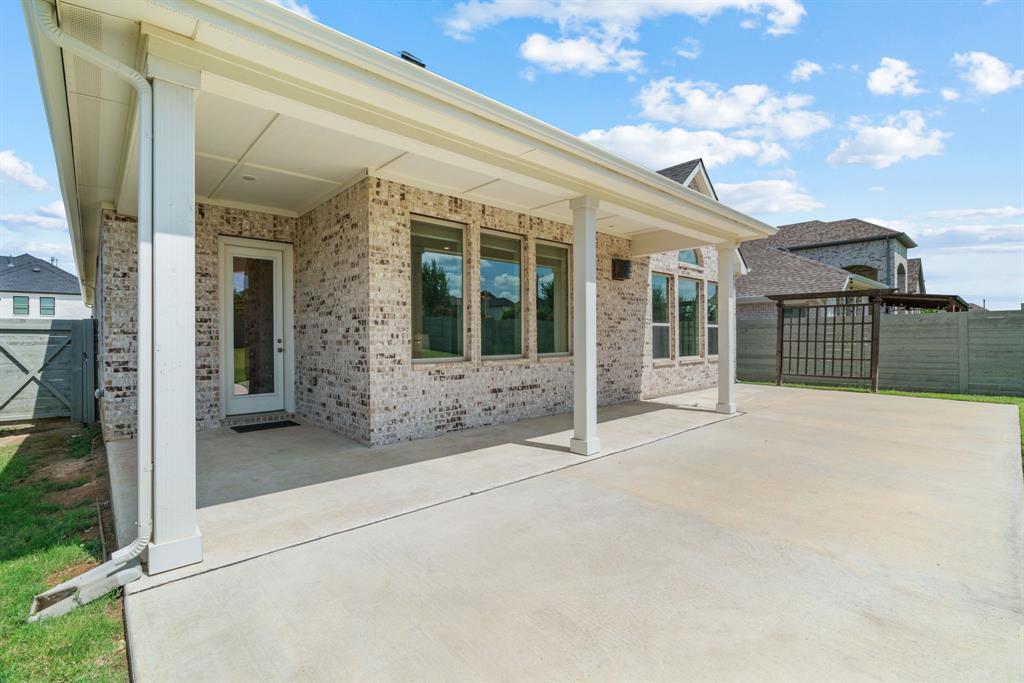 1821 Stonewall Road Argyle, TX 76226 - Photo 34 of 40 Expansive concrete patio extending from a covered outdoor living area