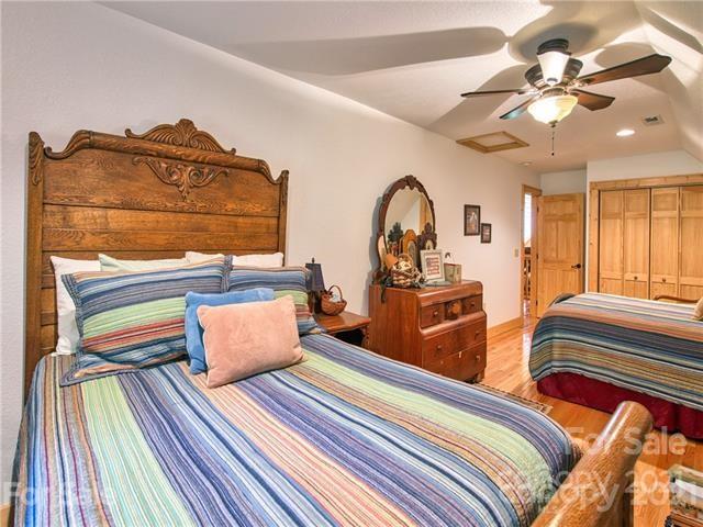 61 Mellow Springs Road Waynesville, NC 28786 - Photo 22 of 43 a bedroom with furniture and a wooden floor