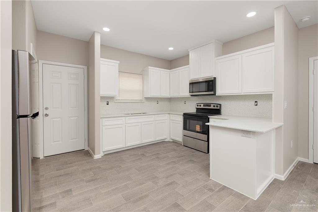 2808 West Harrison Avenue, Unit 4 Alton, TX 78573 - Photo 13 of 22 a kitchen with a sink stainless steel appliances and cabinets