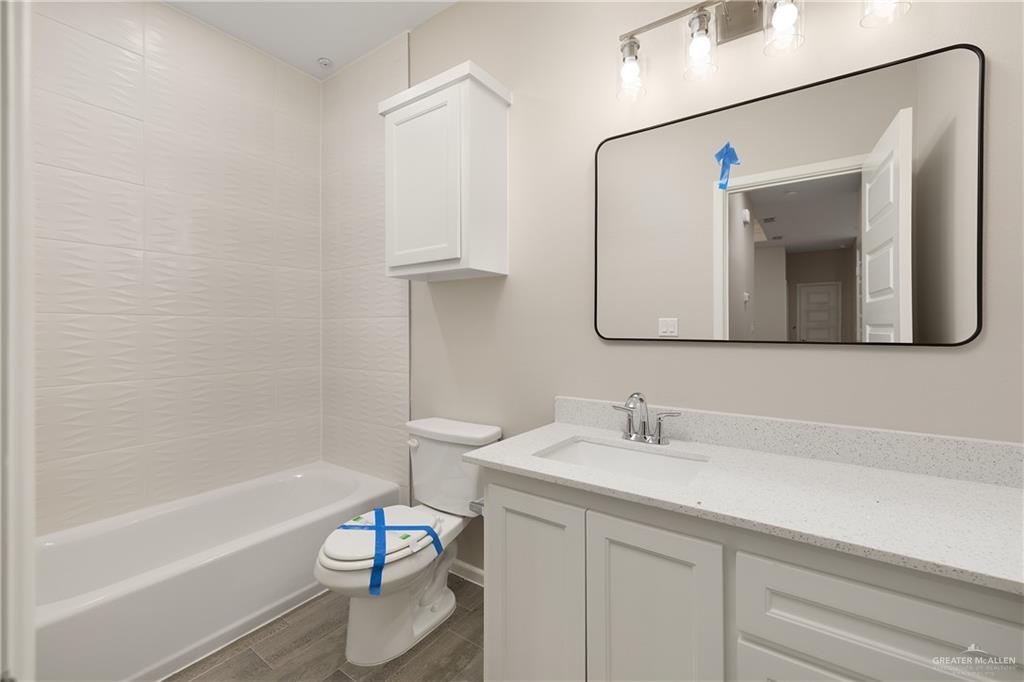 2808 West Harrison Avenue, Unit 4 Alton, TX 78573 - Photo 16 of 22 a bathroom with a sink a toilet and bathtub