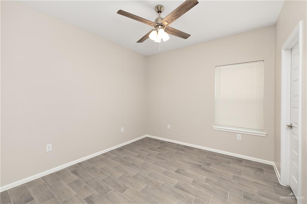2808 West Harrison Avenue, Unit 4 Alton, TX 78573 - Photo 17 of 22 an empty room with a window and a fan