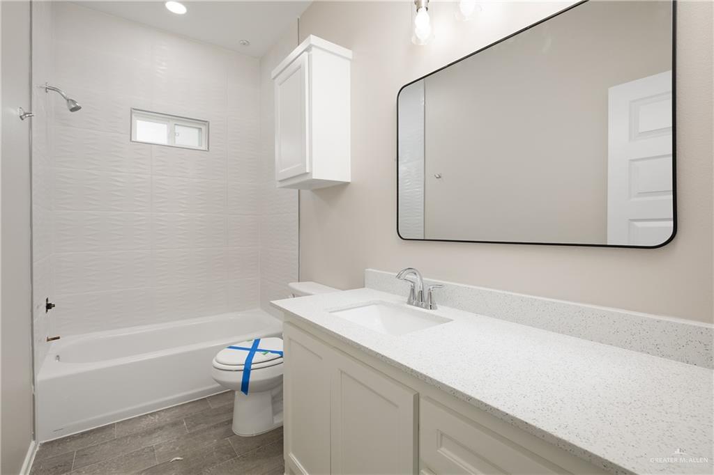 2808 West Harrison Avenue, Unit 4 Alton, TX 78573 - Photo 7 of 22 a bathroom with a sink a toilet and shower