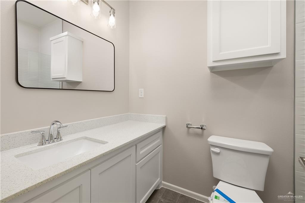 2808 West Harrison Avenue, Unit 4 Alton, TX 78573 - Photo 10 of 22 a bathroom with a sink vanity and a toilet