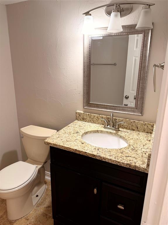 1000 Lamesa Court Irving, TX 75063 - Photo 12 of 28 a bathroom with a granite countertop sink toilet and mirror