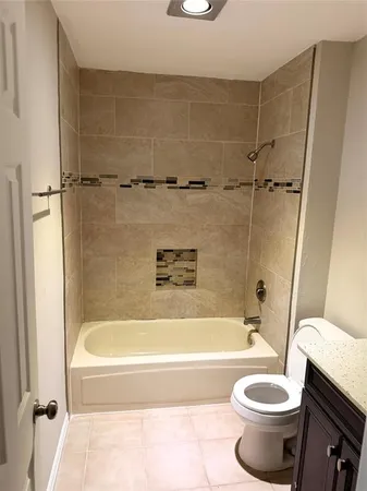 a bath tub sitting next to a white toilet