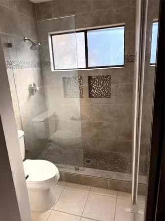 a bathroom with a toilet and a shower