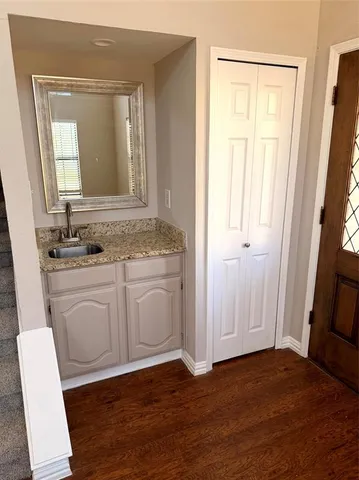 a bathroom with a sink a mirror and a vanity