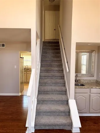 a view of an entryway with wooden floor and staircase