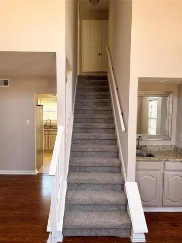 a view of an entryway with wooden floor and staircase