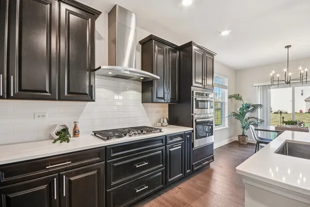 a kitchen with stainless steel appliances granite countertop a stove and a refrigerator