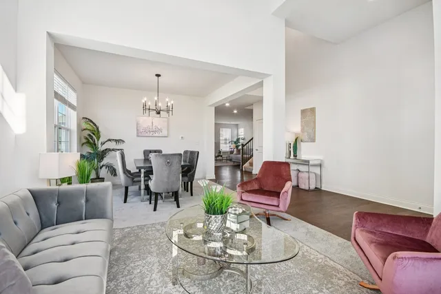 a living room with furniture potted plant and a chandelier