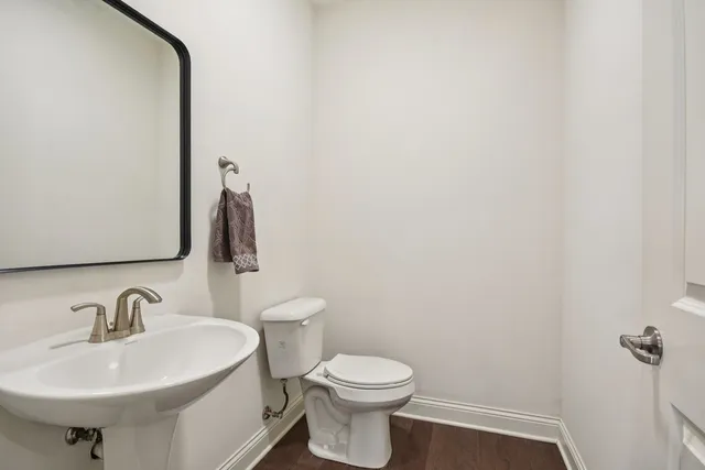 a bathroom with a sink toilet and mirror