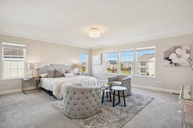 a bedroom with a bed and a table in it with window